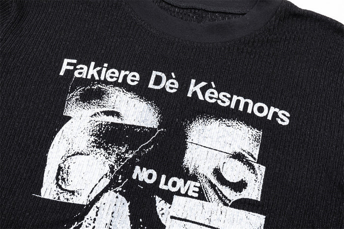 Close-up of the black shirt's upper white graphic with printed text and a monochrome face design