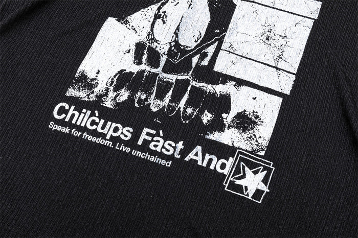 Close-up of the black shirt's lower graphic showing white text, distressed artwork, and a star emblem