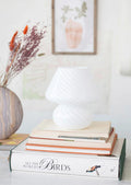 A white art glass table lamp with white/clear spiral pattern.