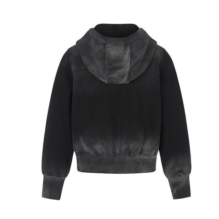 Back view of the black zip-up hoodie showing its plain body, hood, long sleeves and ribbed hem