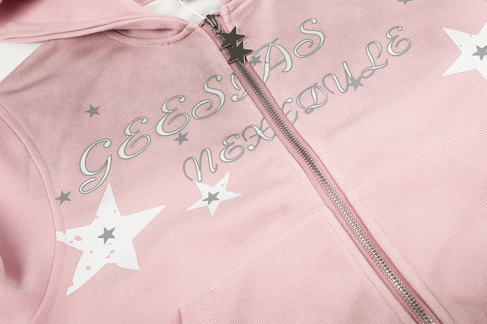 Close-up of the pink hoodie chest showing script lettering, white and gray stars, and the front zipper