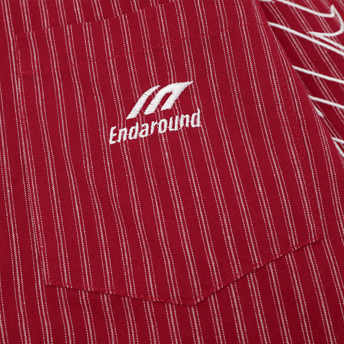 Close-up of chest pocket on red striped shirt with white embroidered logo