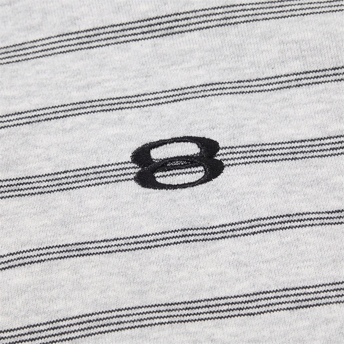 Close-up of the black embroidered loop logo on light gray fabric with horizontal stripes