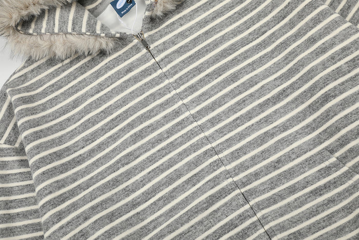Close-up of the gray and cream striped hoodie front showing the zipper, hood edge, and soft textured fabric