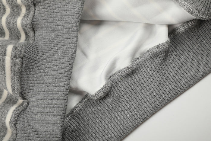 Close-up of the hoodie interior showing smooth white lining and gray ribbed hem construction
