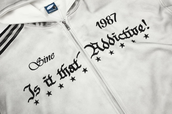 Front chest detail showing black gothic lettering, stars, and 1987 graphic beside the zipper