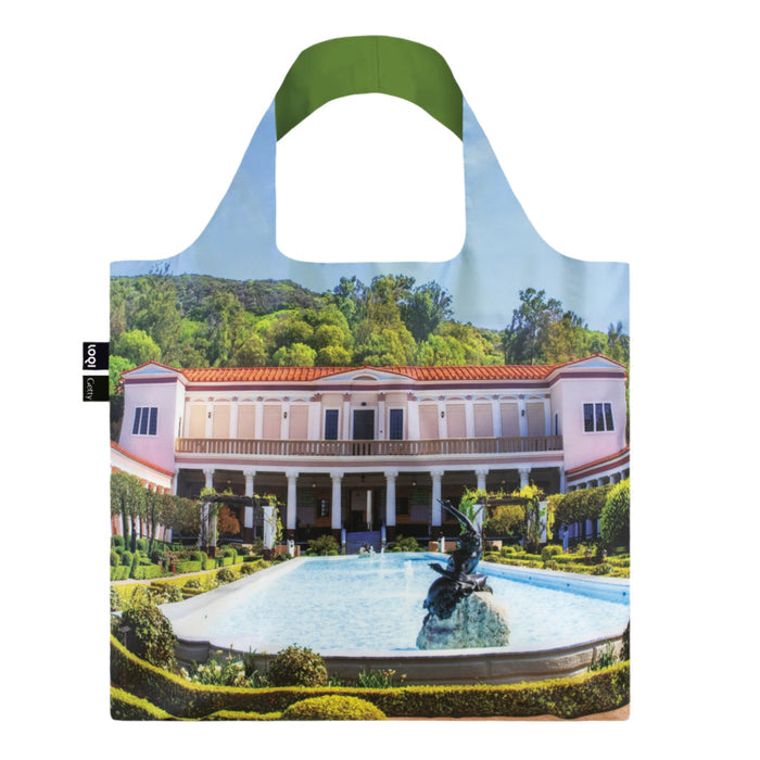 A reusable tote bag featuring an image of the Getty Villa Museum's Outer Peristyle garden, with a green handle and a multicolored building and garden scene.