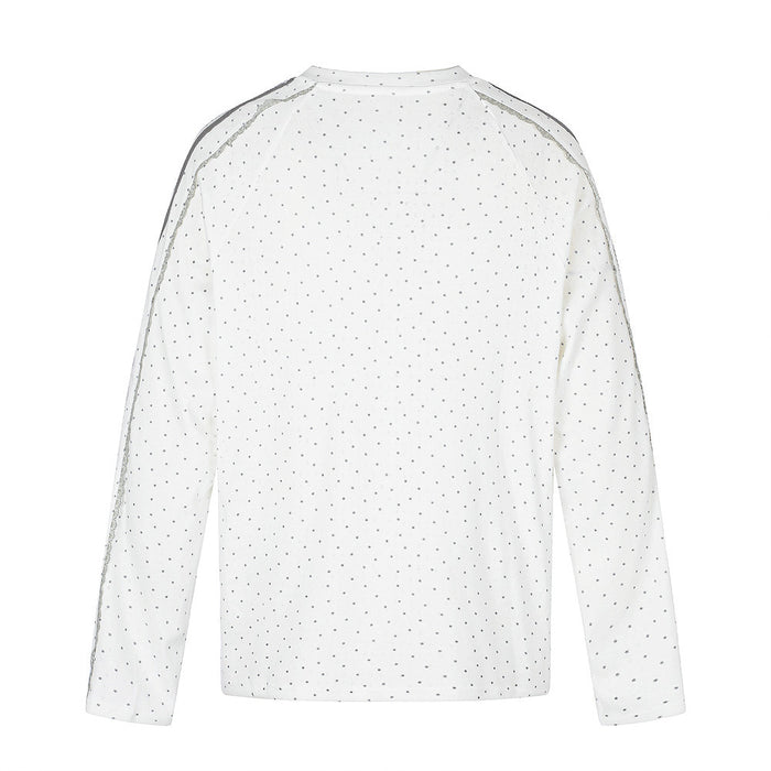 Back view of a white long-sleeve shirt covered in small gray star prints with striped shoulder details