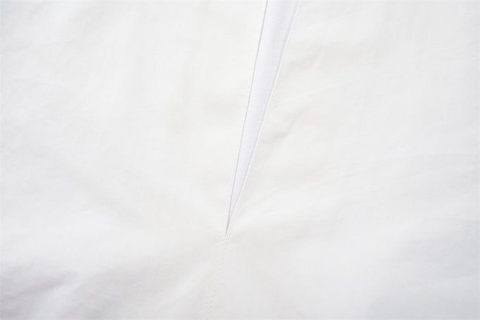 Close-up of the white V-neck placket on the pullover shirt
