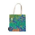 A canvas tote bag featuring the famous painting 'Irises' by Vincent van Gogh with blue and green floral patterns.
