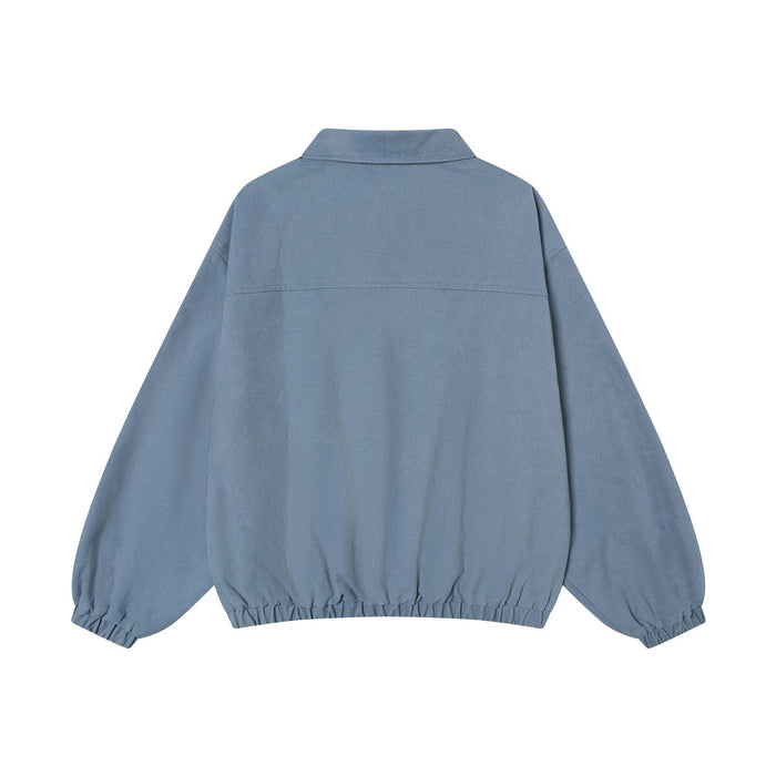 Back view of the washed blue pullover training jacket with a polo collar, long sleeves, and elastic hem