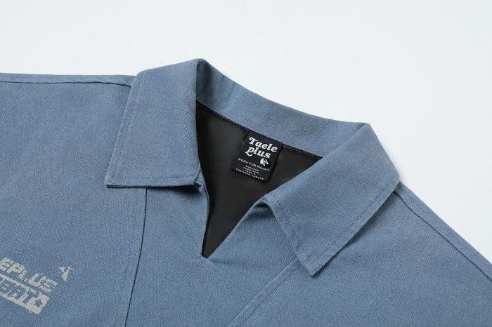 Close-up of the washed blue jacket’s polo collar, V-neck opening, stitching, and inner neck label