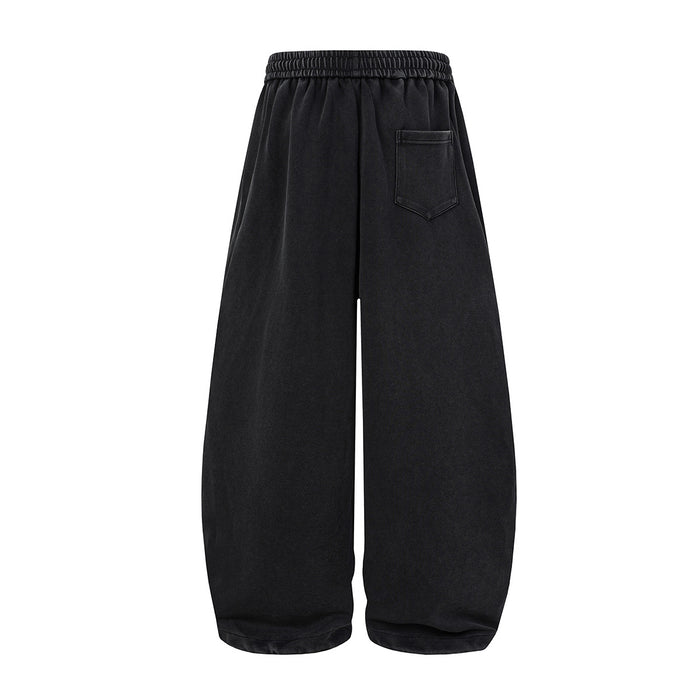 Black wide-leg sweatpants shown from the back with an elastic waistband and single stitched back pocket