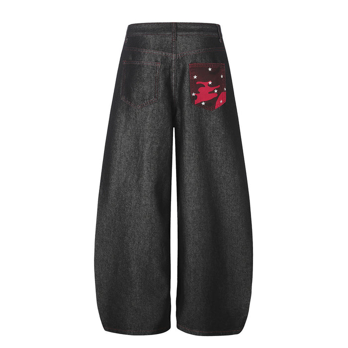 Back view of black wide-leg barrel jeans with red stitching and a red star graphic back pocket