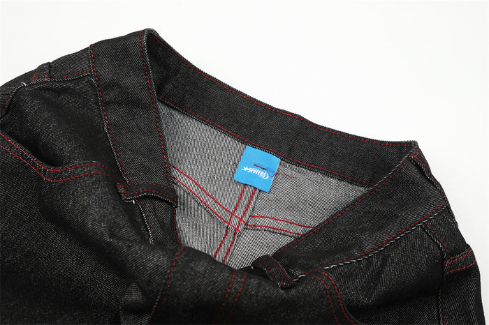 Close-up of inside waistband with blue label and red stitched seam details