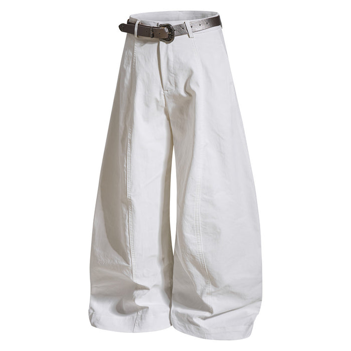 White oversized curved-leg trousers in a front view with a brown belt