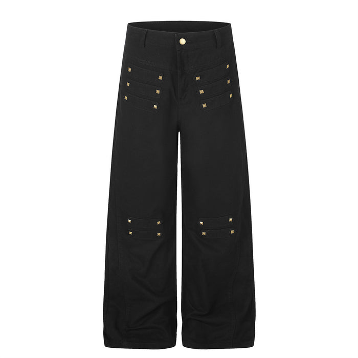 Wide-leg cargo pants with gold pyramid studs in black, front view showing stitched panel detailing and relaxed straight-cut s