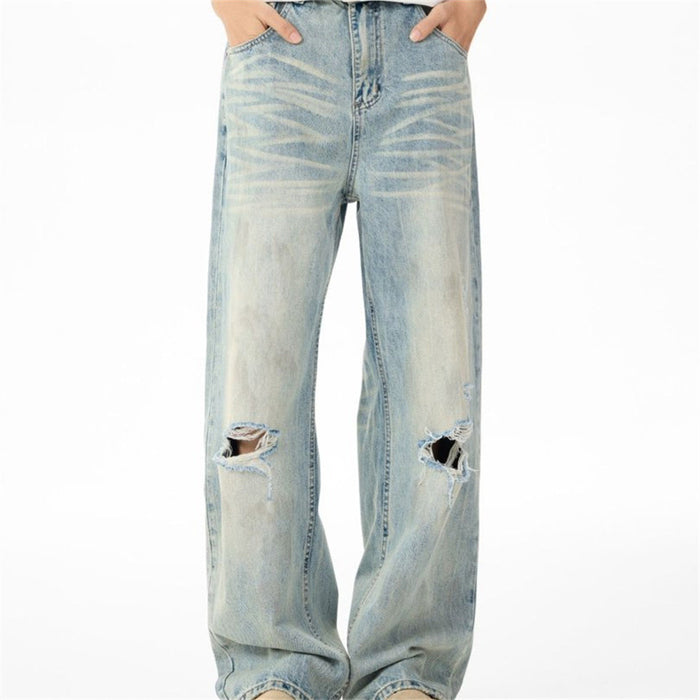 Front view of light-wash wide-leg jeans with whiskering and ripped knees on both legs