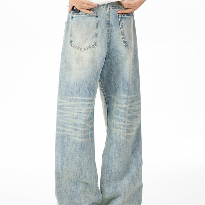 Back view of light-wash wide-leg jeans showing two patch pockets and faded whiskering