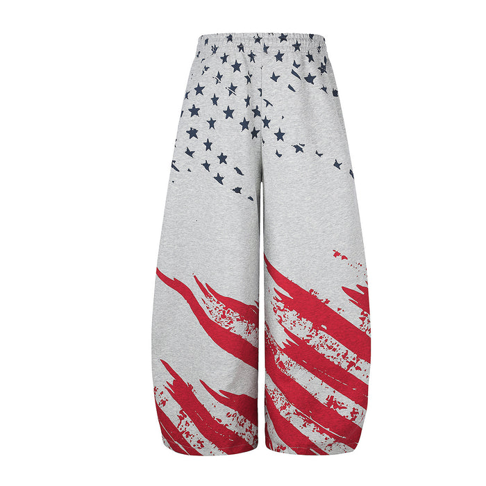 Back view of gray wide-leg pants covered with navy stars and bold red brushstroke stripes