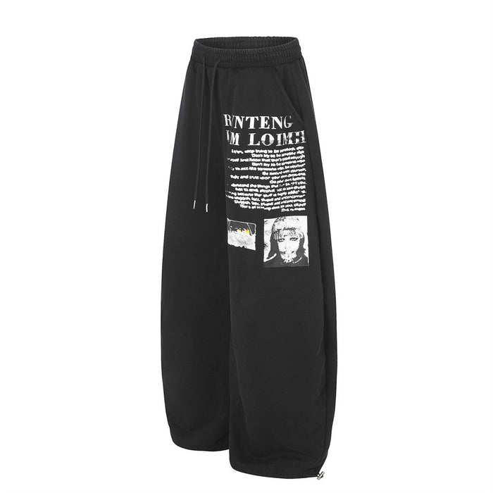 Black wide-leg sweatpants with white graphic letter print, angled front view