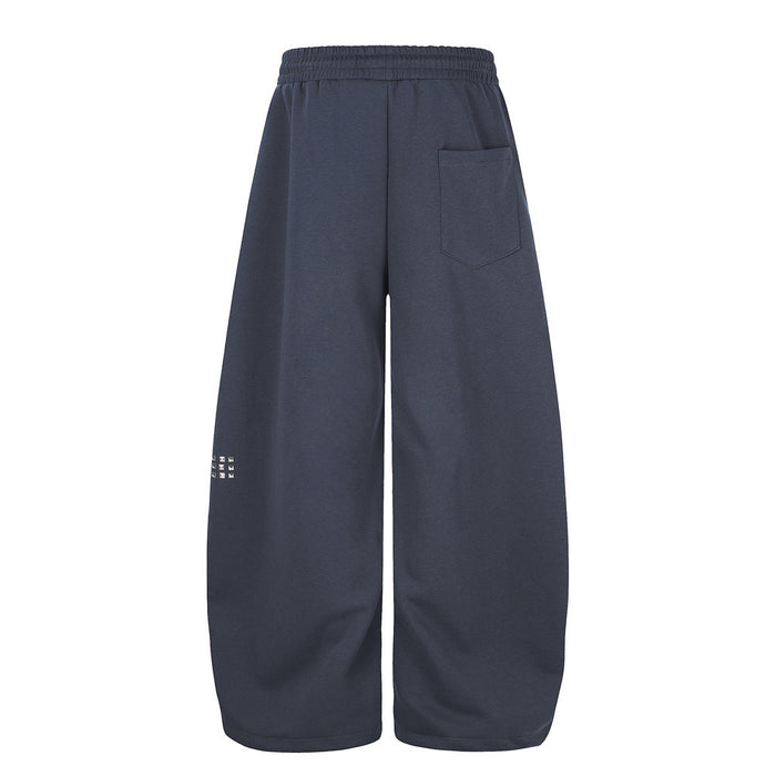 Navy wide leg sweatpants back view with single patch pocket and small rhinestone detail on leg
