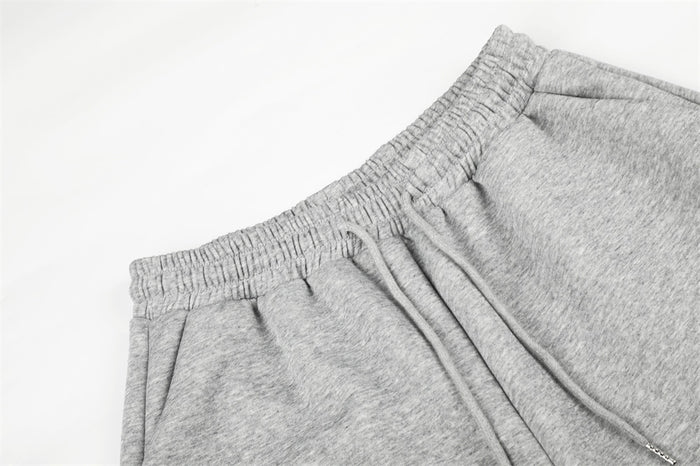 Close-up of gray elastic waistband with drawstring and gathered waist on sweatpants
