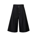 Front view of black wide-leg pleated culottes shorts with high waist and button fly