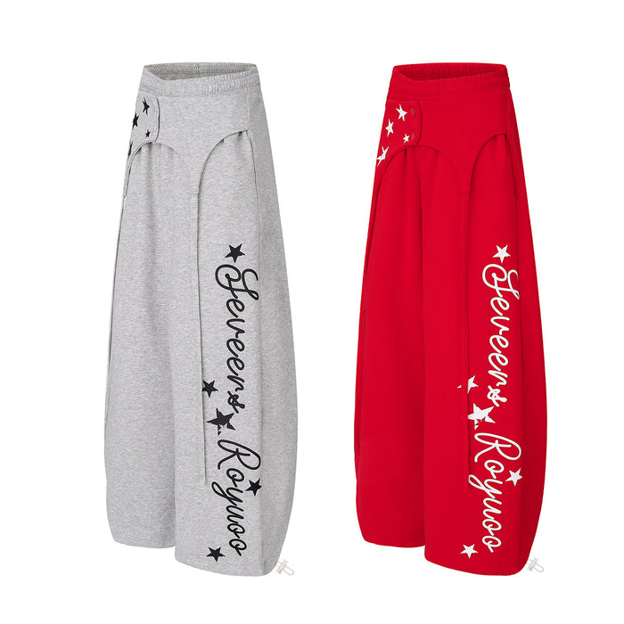 Angled views of gray and red wide-leg sweatpants showing side script graphics and scattered star prints