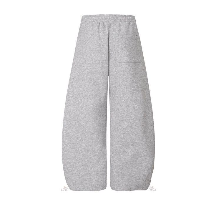 Back view of plain gray wide-leg sweatpants with an elastic waistband and loose straight legs