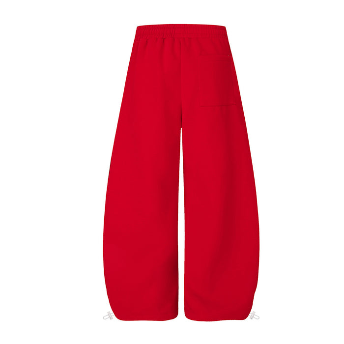 Back view of plain red wide-leg sweatpants with an elastic waistband and loose full-length legs