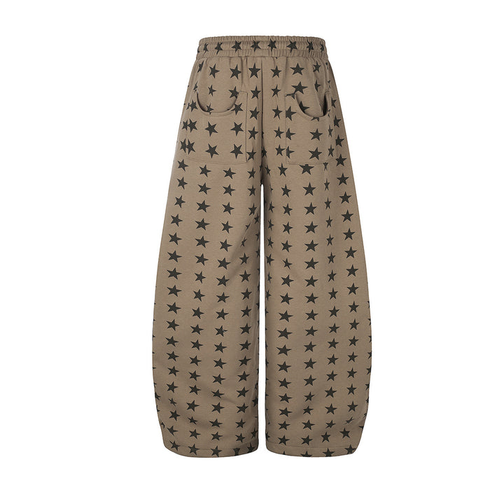 Front view of taupe wide-leg sweatpants featuring black stars, an elastic waistband, and curved pockets