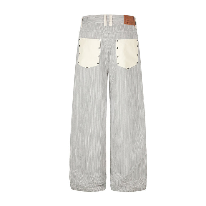 Back view of wide-leg striped jeans with two cream patch pockets and a brown waistband label