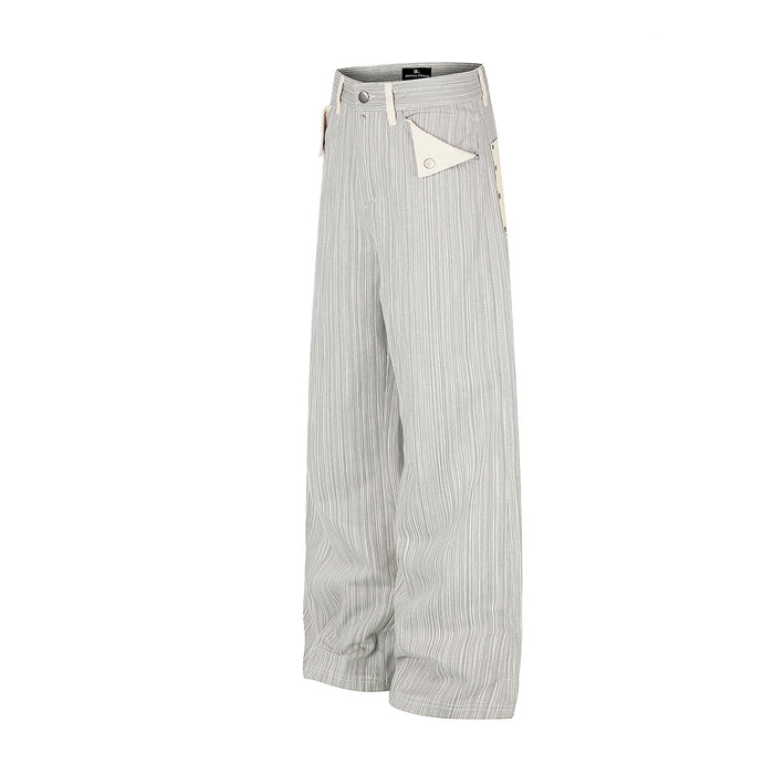 Angled side view of gray and white striped wide-leg jeans with triangular cream front pockets