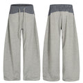 Grey wide-leg sweatpants with navy check contrast layered waistband, front and back view on white background
