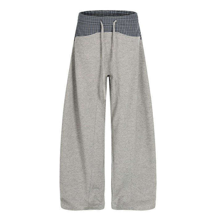 Wide-leg gray sweatpants with navy plaid contrast waistband, front view