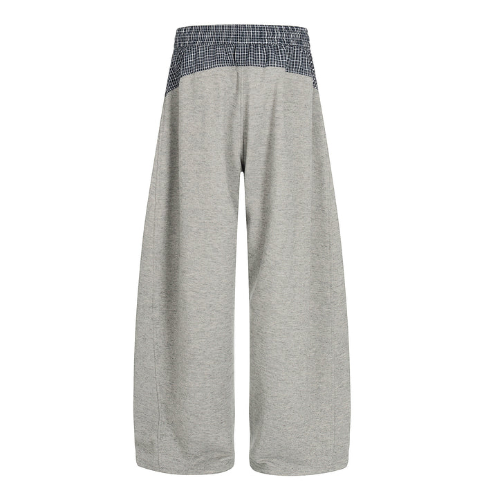 Back view of wide-leg gray sweatpants with navy plaid contrast waistband