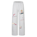 Gray wide-leg sweatpants with an elastic waistband and colorful cartoon, heart, and text prints on the front